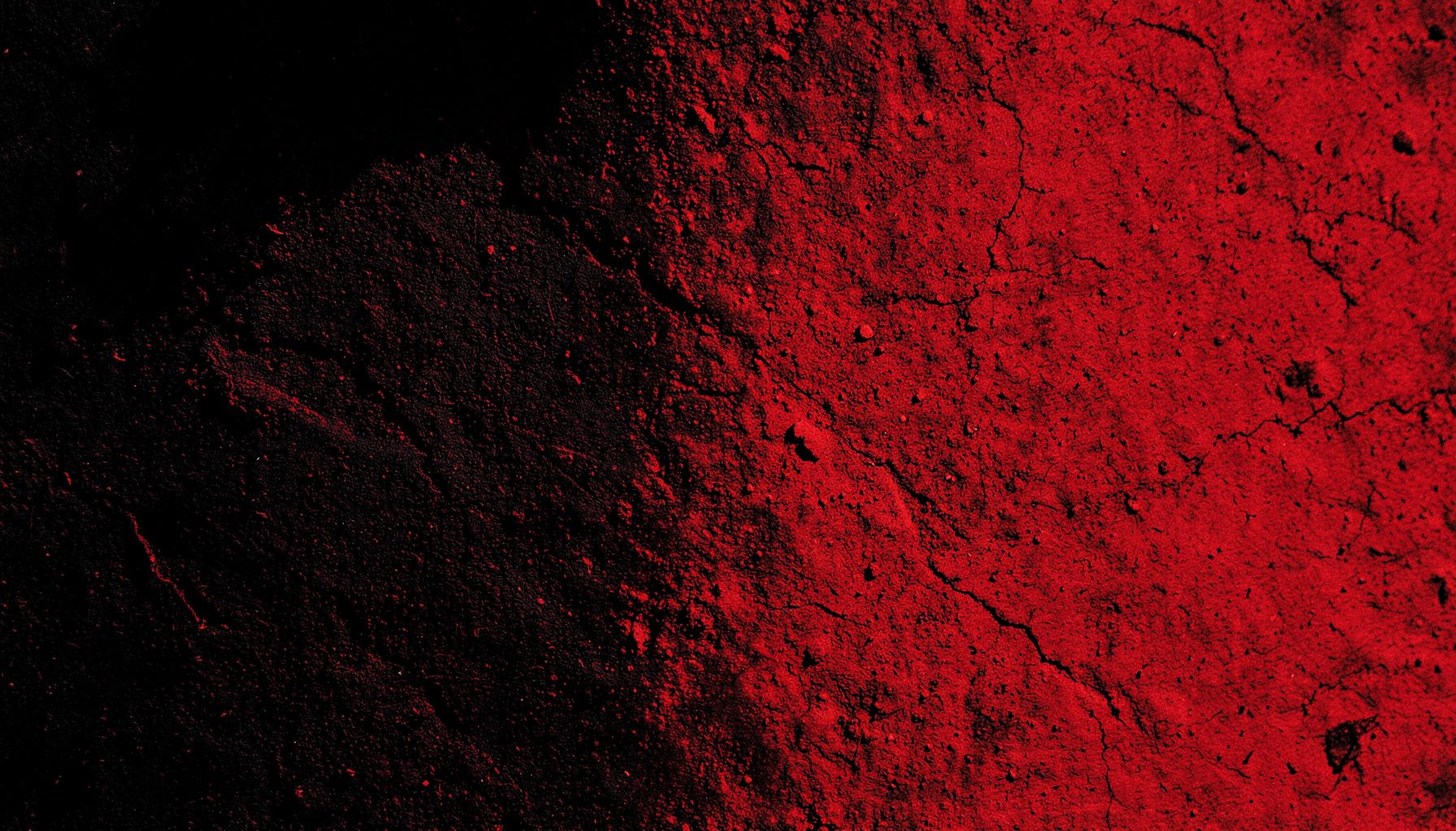 Dipinto materico con superfici ruvide nei toni del nero, rosso scuro e ocra, reso in duotono.